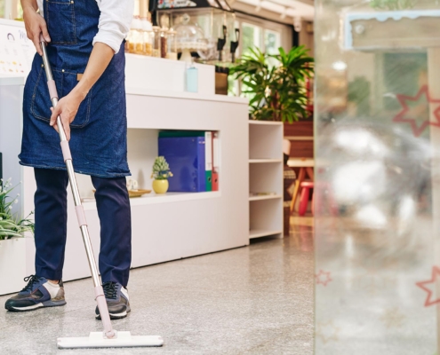 Janitor cleaning floor of retail store