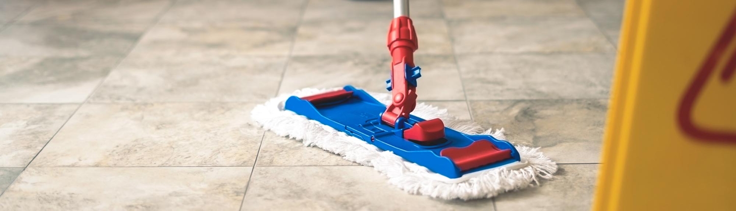 Side view of someone mopping a linoleum floor