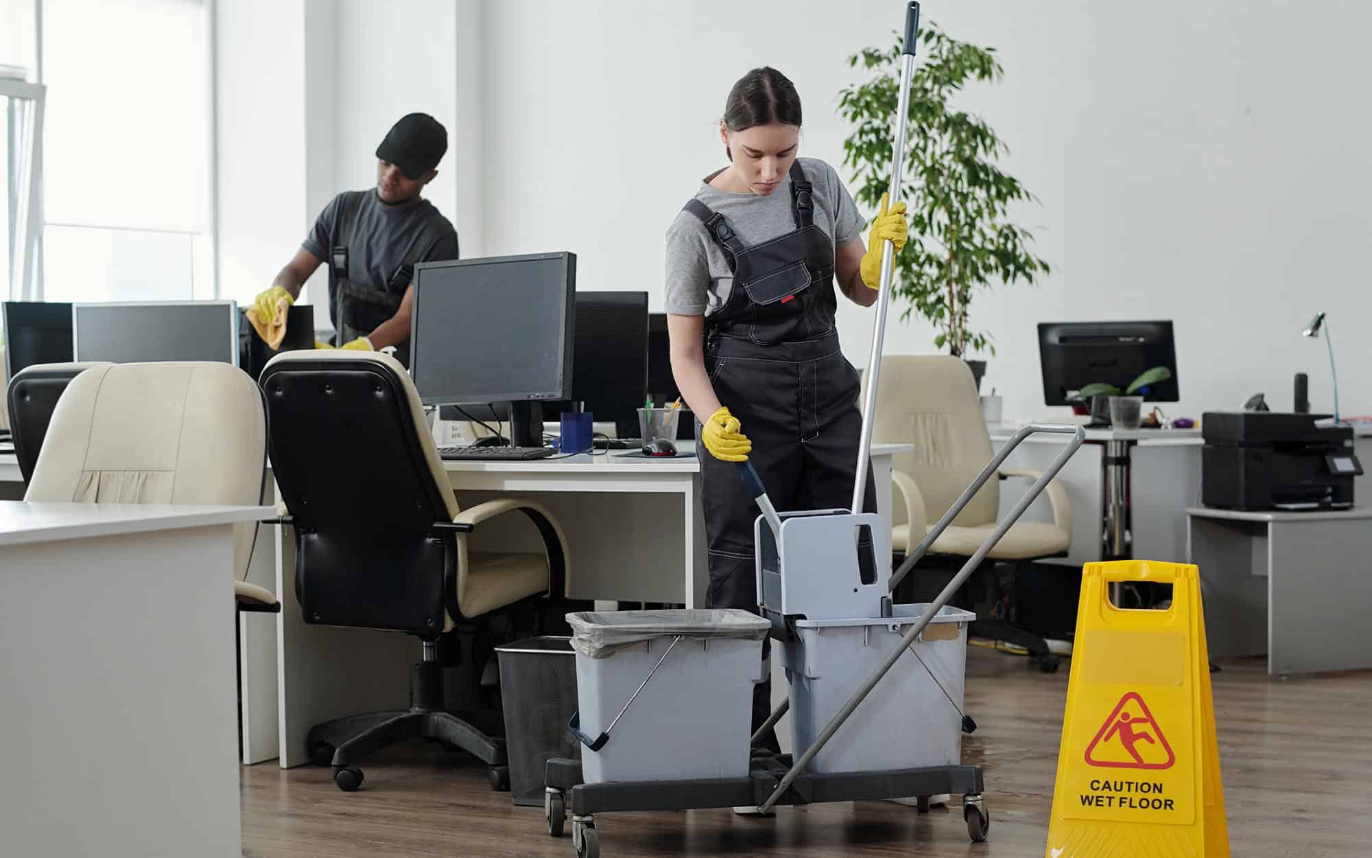 Side view of two janitors cleaning