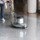 Woman cleaning the floor with polishing machine