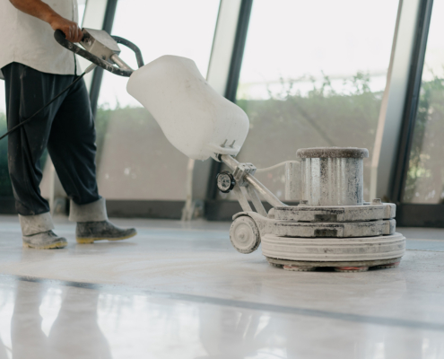 Side view, cleaning floor with machine