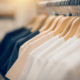 T-shirts on hangers. Shopping in store. Clothes on hangers in shop for sale