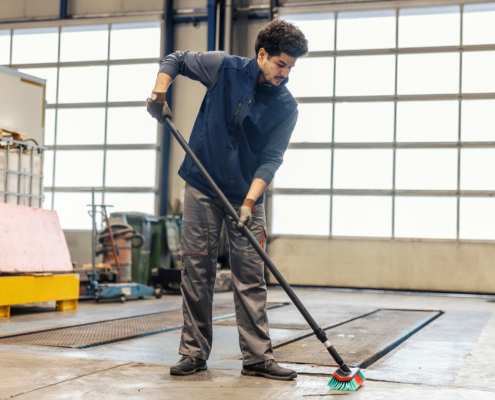 Worker cleaning up warehouse_
