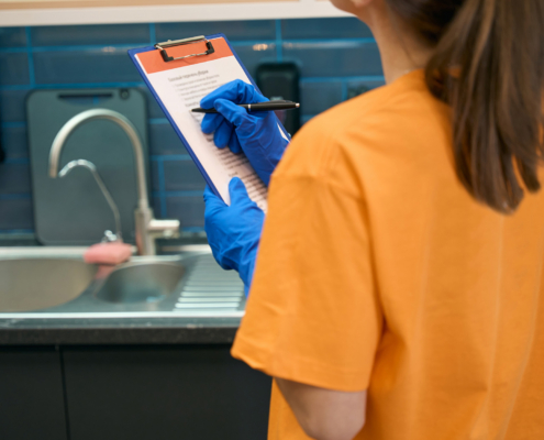 person using cleaning checklist